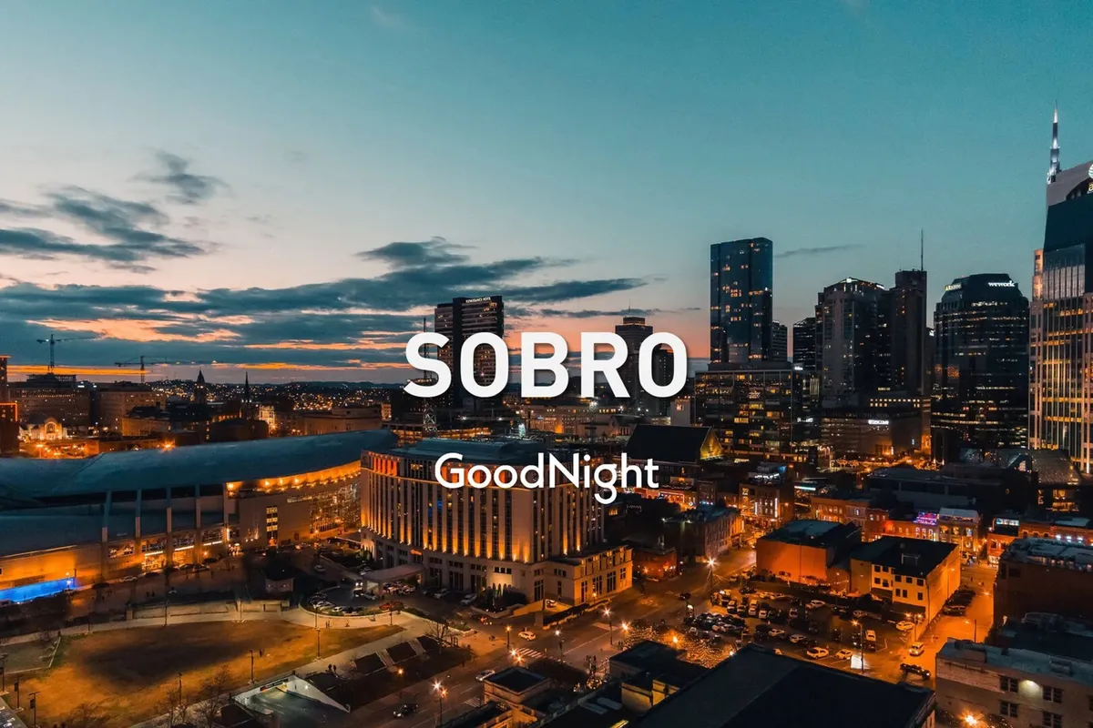 A panoramic view of the Nashville city skyline at sunset, with urban architecture and glowing street lights. The mood is inviting and lively, suggesting an evening of dining and nightlife adventures in the city.