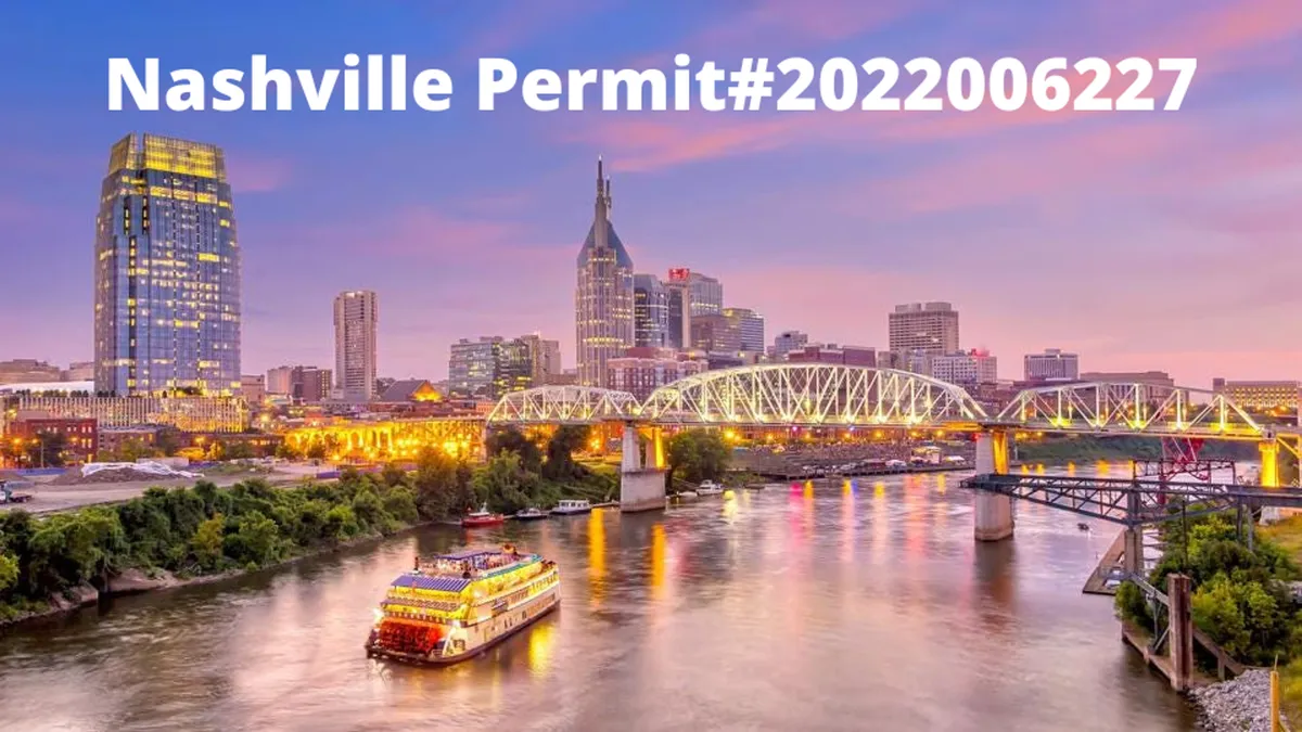 A panoramic view of the Nashville skyline with a riverboat cruising along the river and bridges spanning the water. The city lights contrast with the natural beauty of the river, offering an inviting glimpse of the city’s dynamic yet approachable vibe.